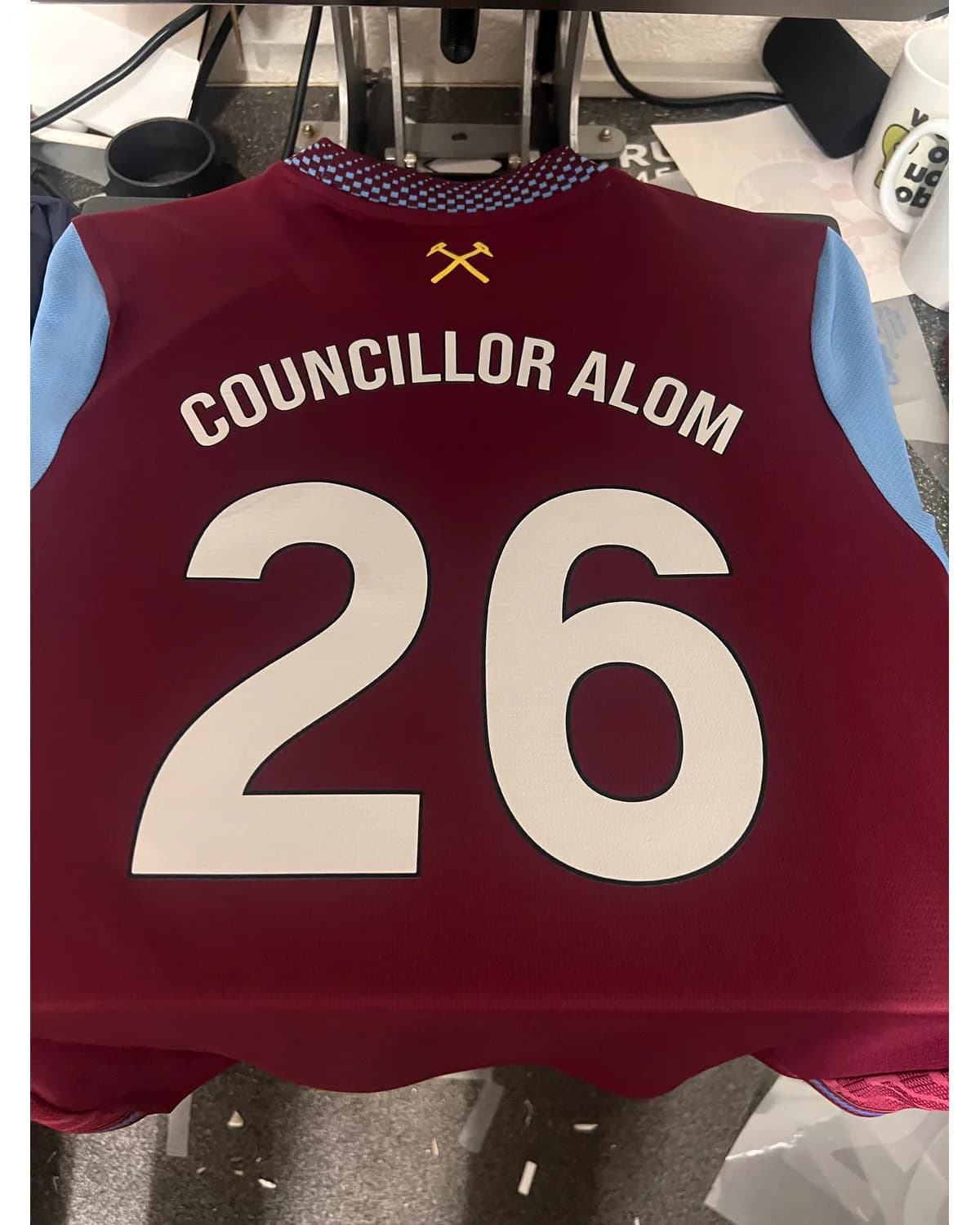 Claret and blue sports shirt with a white personalised name and number 26