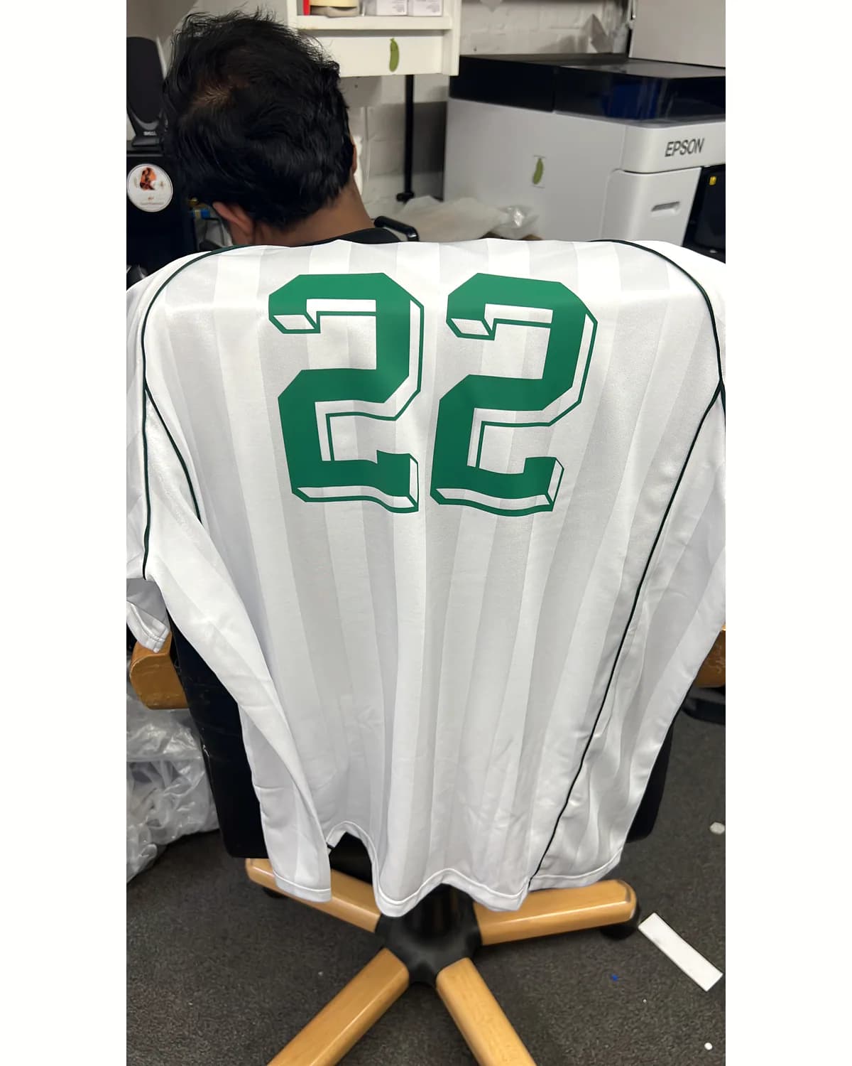 Finished white football jersey with a custom green number 22