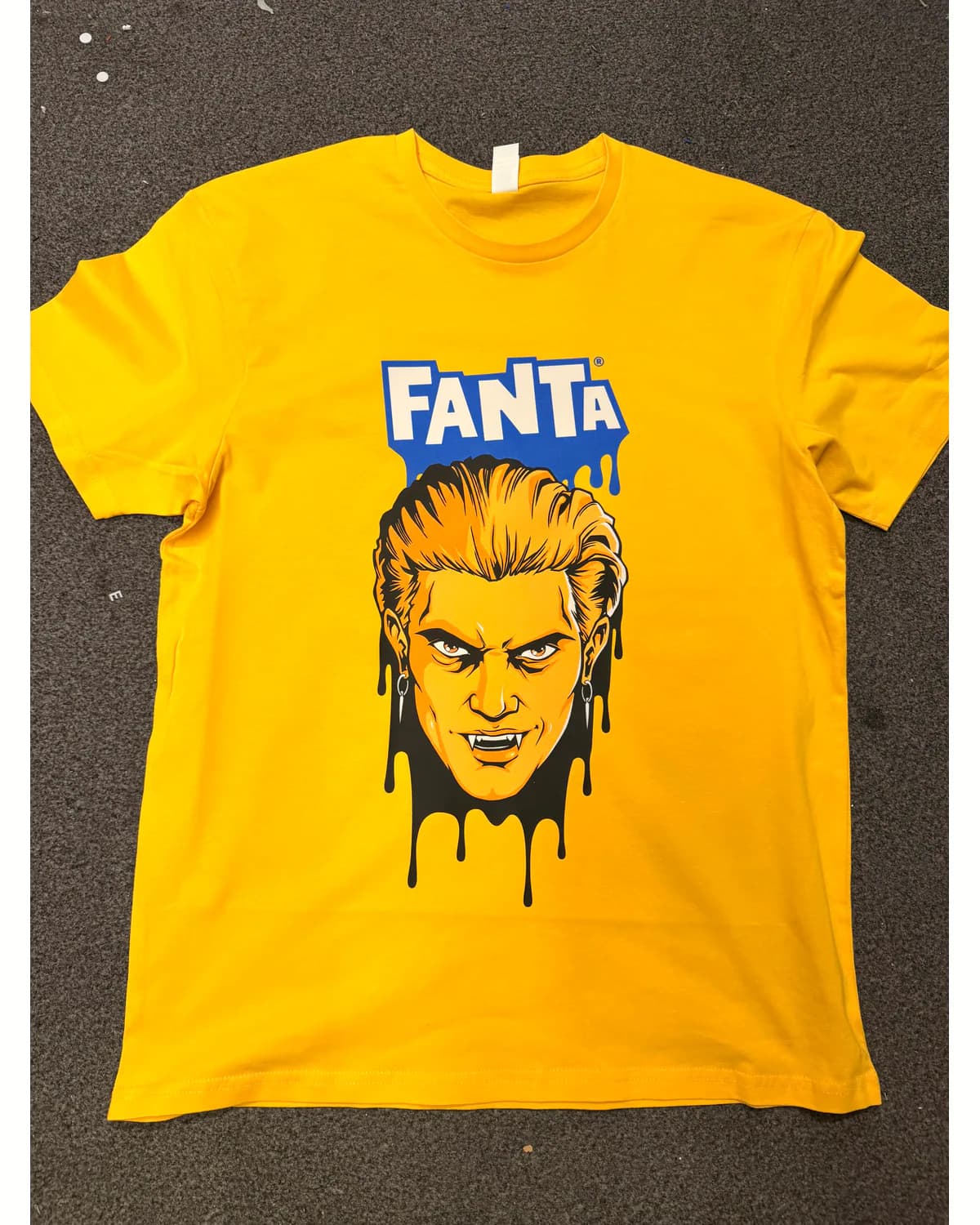 Yellow T shirt with a blue black and orange pop-art print
