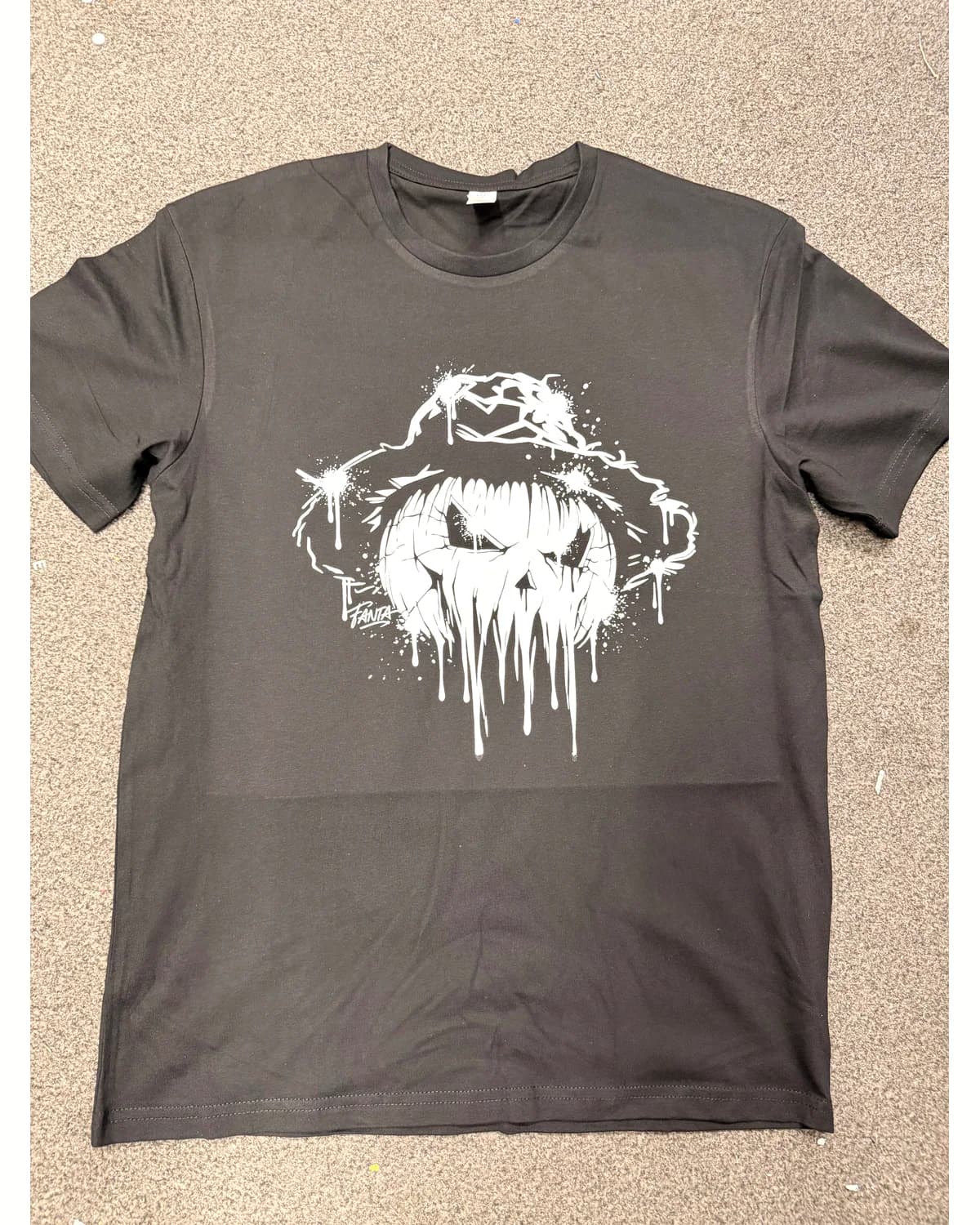 Dark T shirt with a distressed white illustrated face print