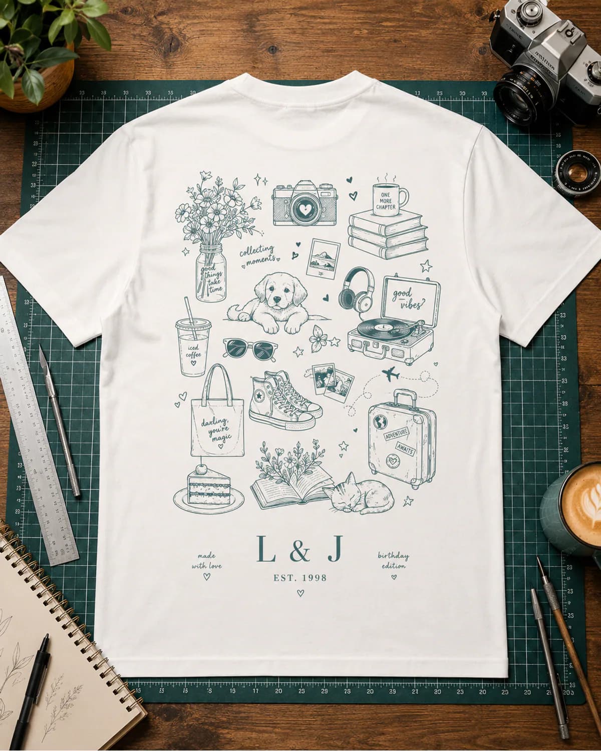 White T shirt with a detailed teal illustrated milestone print