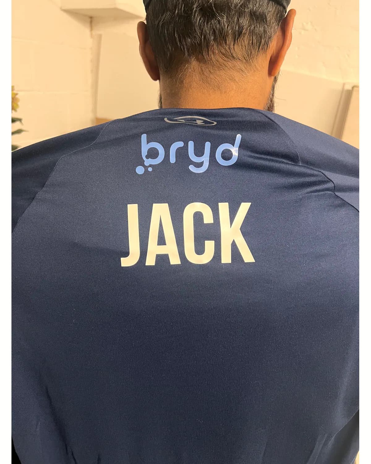 Navy football shirt with a personalised white name on the back