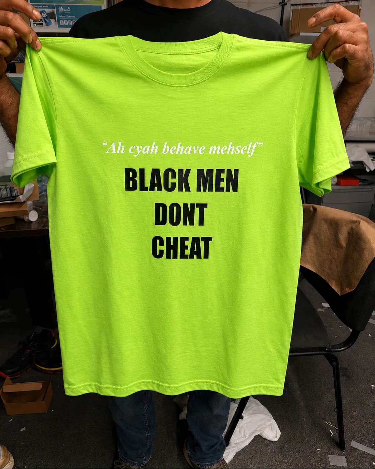 Neon green T shirt with contrasting white and black statement lettering