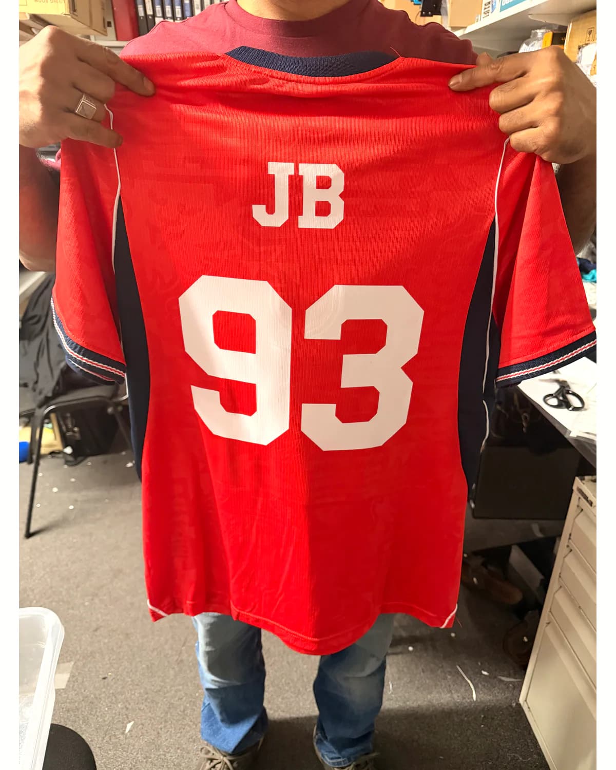 Red sports shirt with a custom white name and number 93