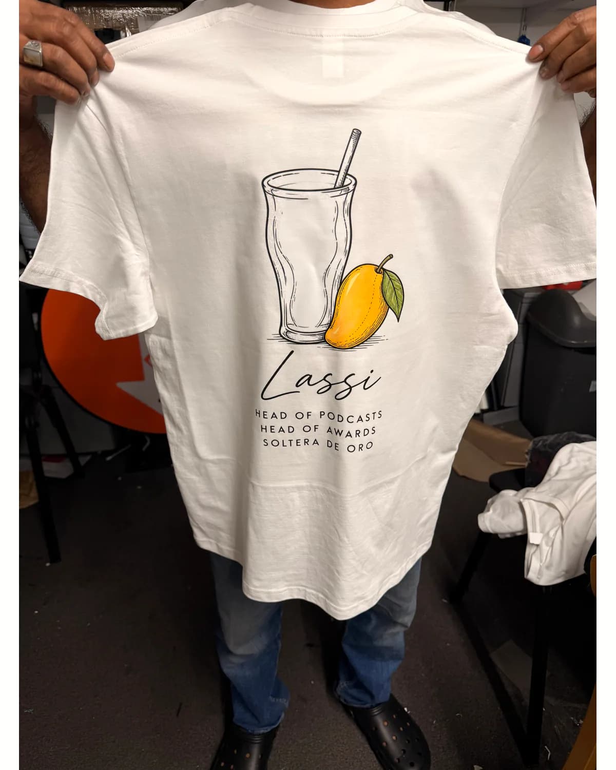 White T shirt with a small illustrated drink logo and business text