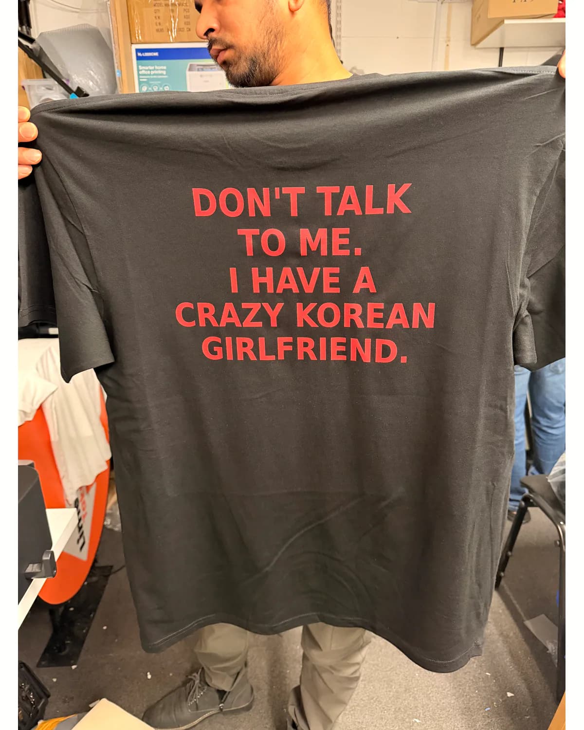 Dark T shirt with a bold red multi-line slogan print